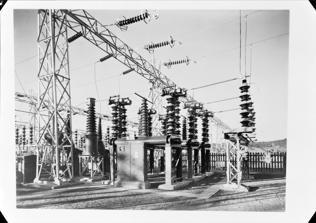 Archival black and white photograph of an electrical substation feeding power through a small number of major lines, illustrating concentrated customer dependency